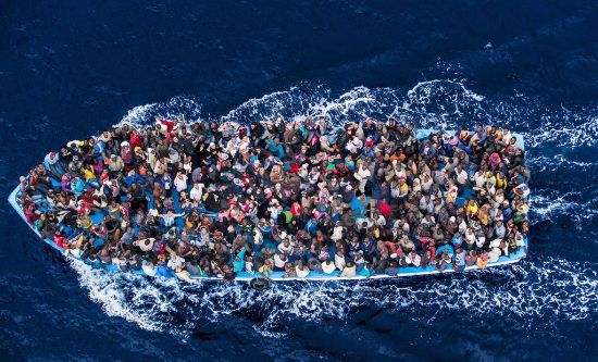 Photo of a boat crowded with refugees (from Italian Coast Guard)