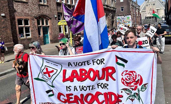 Liverpool FRFI marches with the banner: 'A vote for Labour is a vote for genocide'. (Photo: FRFI)