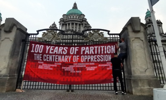 Banner on the gates of Stormont reads '100 years of partition: the centenary of oppression'